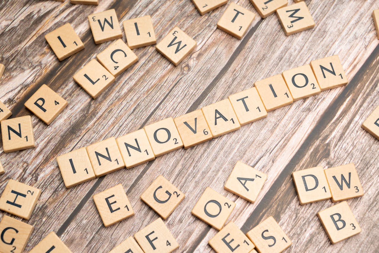who-we-are Creative display of 'Innovation' spelled with wooden letter tiles on a wooden surface.