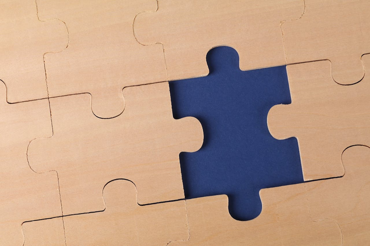 why-choose-us Close-up of an unfinished wooden puzzle with a missing piece, highlighting problem-solving concepts.
